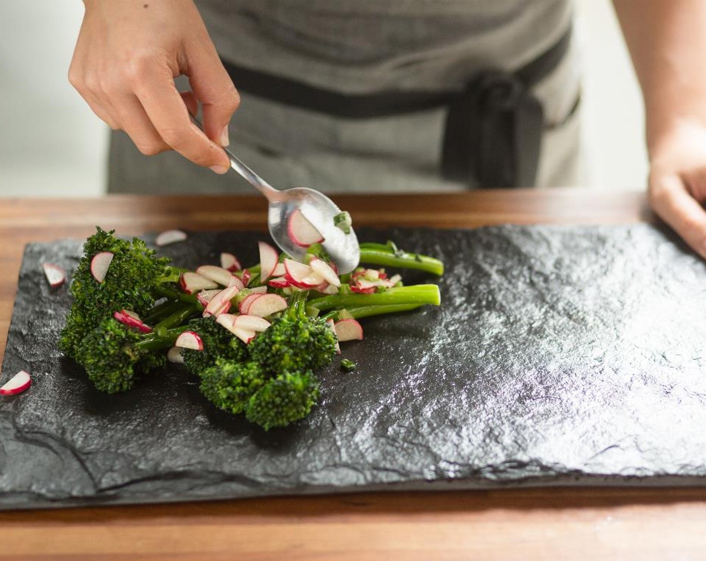 step 12 Arrange the slices of steak on each of two plates. Place the Broccolini Radish Salad next to the steak. Serve and enjoy!