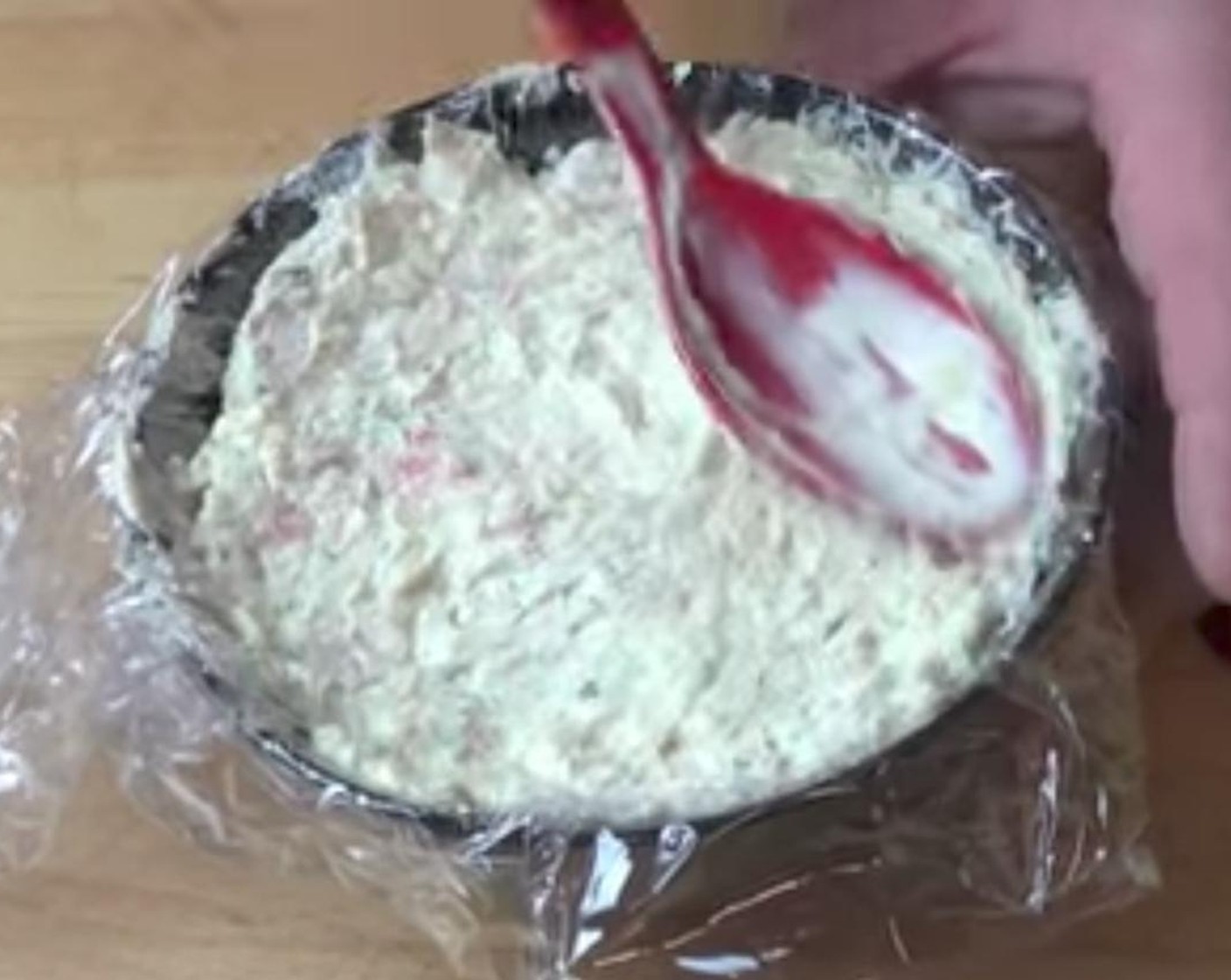 step 4 Line a soup bowl with kitchen wrap and transfer the mixture into the bowl. Press a spoon on top so that all the mixture is in the bowl.