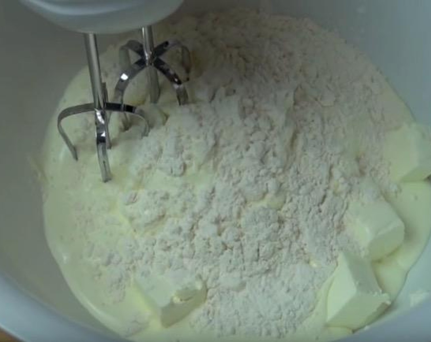 step 3 In a mixing bowl, add Cream Cheese (1 cup), Ricotta Cheese (1 2/3 cups), Whipping Cream (1 cup) and All-Purpose Flour (3 Tbsp). Using an electric mixer, beat until smooth.