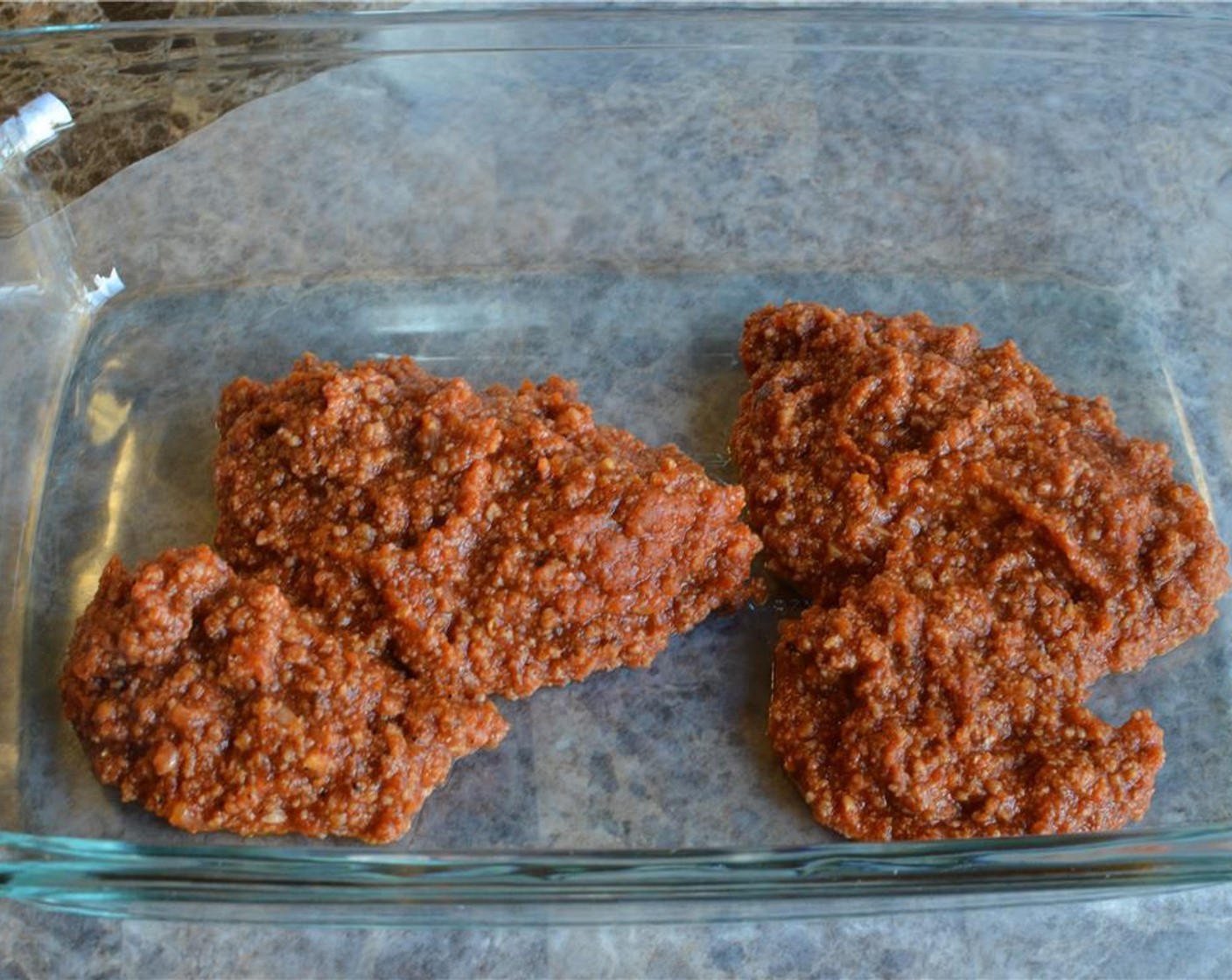 step 12 In the bottom of the baking dish you're going to use, spread a thin layer of the meat sauce.