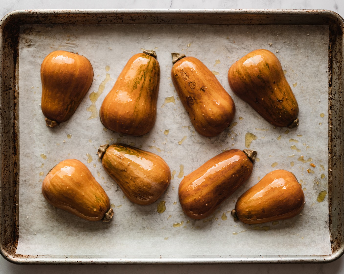 step 2 Rub your prepared Honeynut Squash (4) with Olive Oil (1 Tbsp), making sure to oil the squash flesh and skin. Sprinkle the cut side of the squashes with Salt (to taste) and set the flesh side down on the prepared baking sheet.