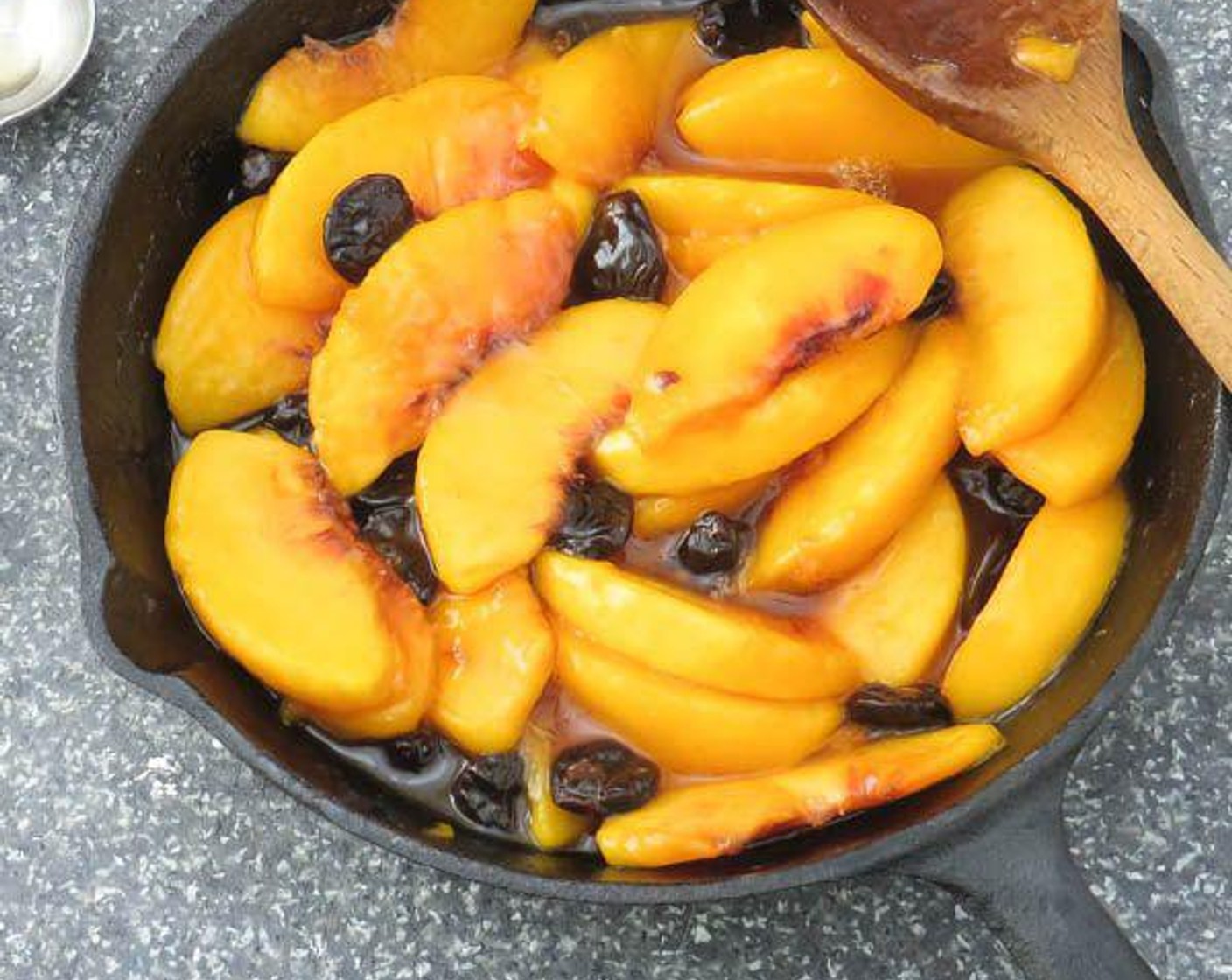step 4 Stir until combined, then set aside. Melt Butter (2 Tbsp) in a small cast iron skillet over medium heat. Add peaches, amaretto soaked cherries, Granulated Sugar (1 Tbsp) and Corn Starch (1/2 tsp). Cook for 2-3 minutes until liquid thickens slightly.