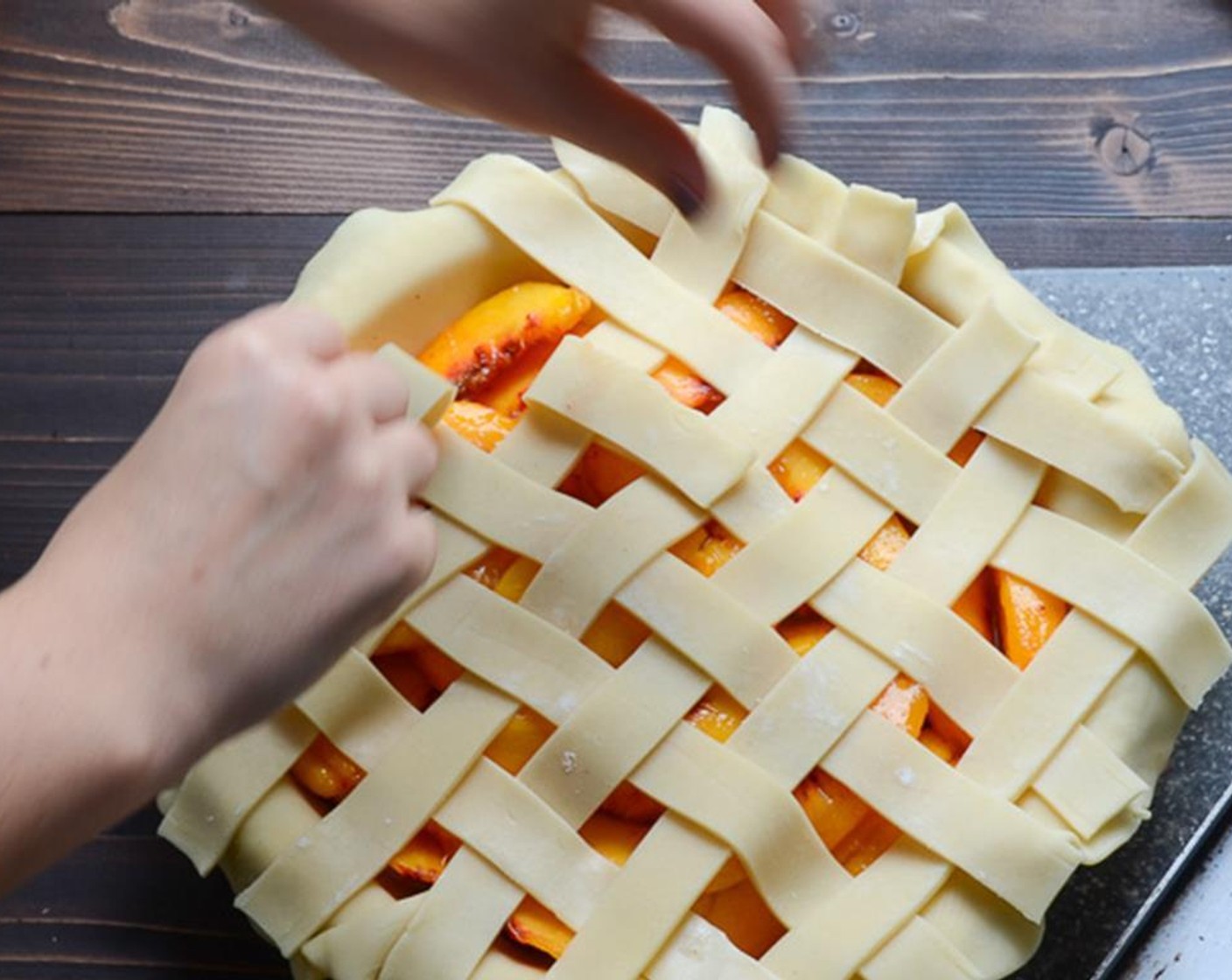 step 9 Lay 5 strips of pie crust evenly across the peaches parallel to one another. Weave remaining strips perpendicular to the first ones, to create a lattice crust.
