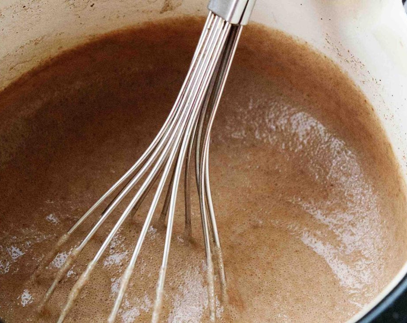step 2 Then bring pot to low heat and stirring constantly with a whisk, pour in the Eggs (3). Keep stirring until mixture reach simmering point and thickens up.​
