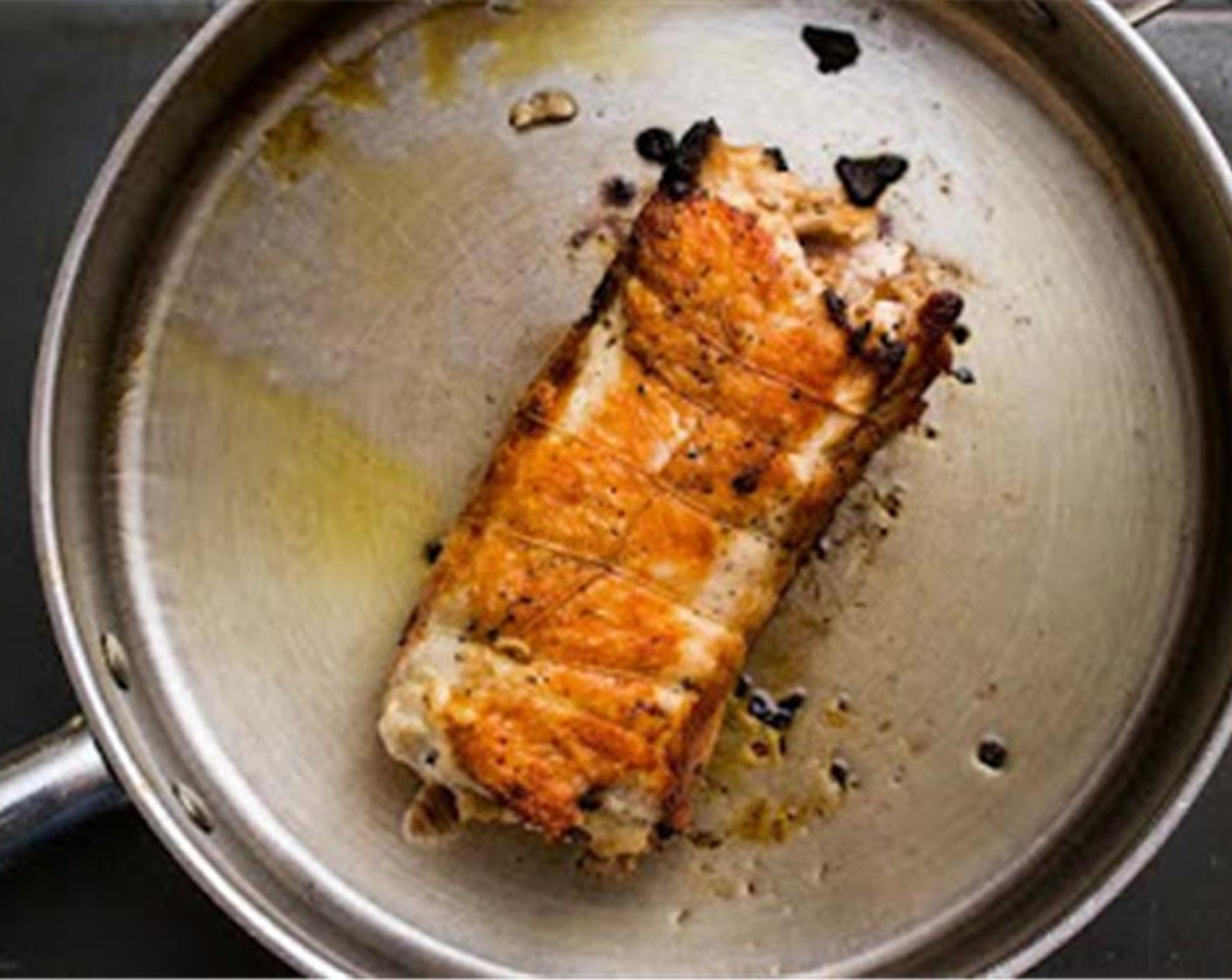 step 10 In a dutch oven or other large pan (you want a vessel deep enough to be able to cover the roulade tightly with a lid for roasting), warm the Canola Oil (2 Tbsp) over medium-high heat.
