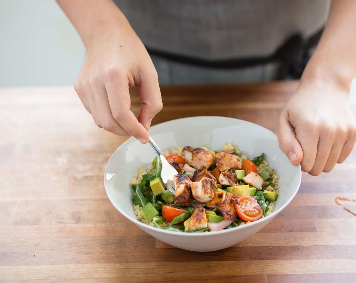 step 13 Evenly distribute the lime quinoa between two bowls. Place the arugula salad over the quinoa. Top with the Chipotle Chicken. Serve and enjoy!