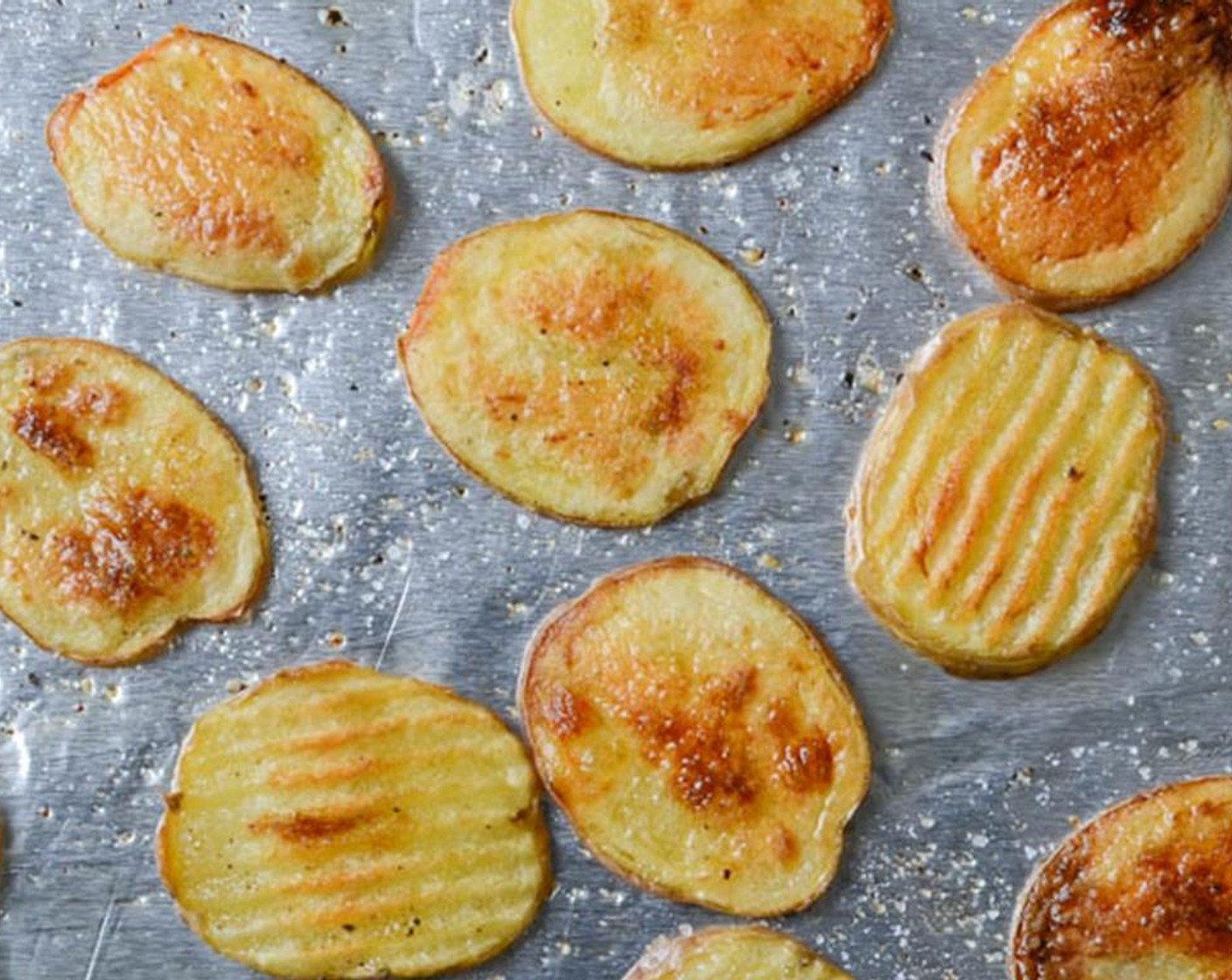 step 5 Remove from oven and flip potatoes over. Return the baking sheet to the oven and cook for an additional 10-12 minutes or until potatoes are golden and crisp. Remove from oven and set aside.