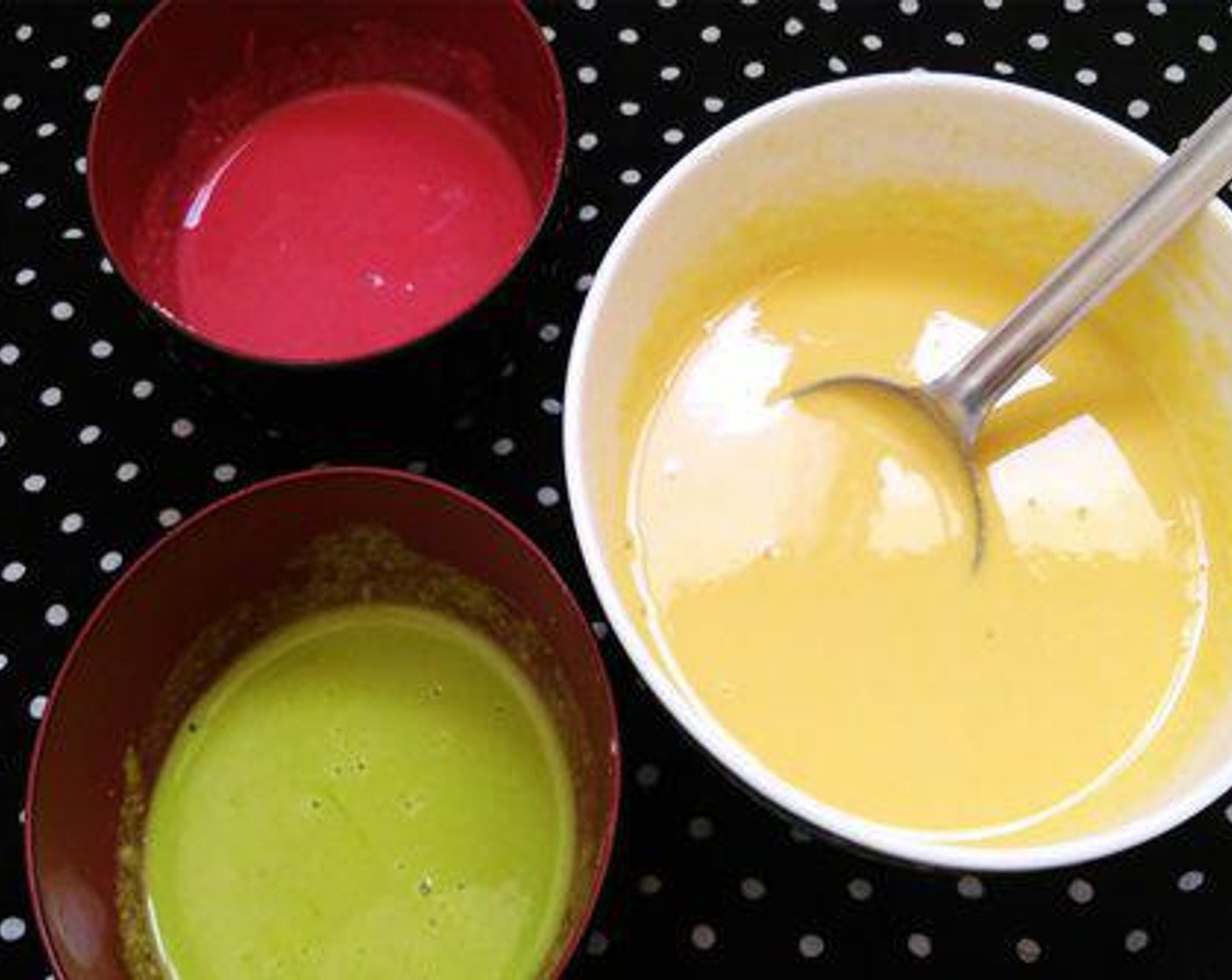 step 3 Here I am making three colors boondhi. I divided the batter in to three bowls, one red, one yellow, and one Green Food Coloring (1 drop).