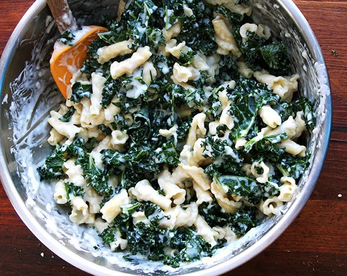 step 3 Chop the Kale (9 cups) into small pieces. In a large mixing bowl, toss pasta with thickened bechamel and Parmesan Cheese (1 1/2 cups), then fold in chopped kale.