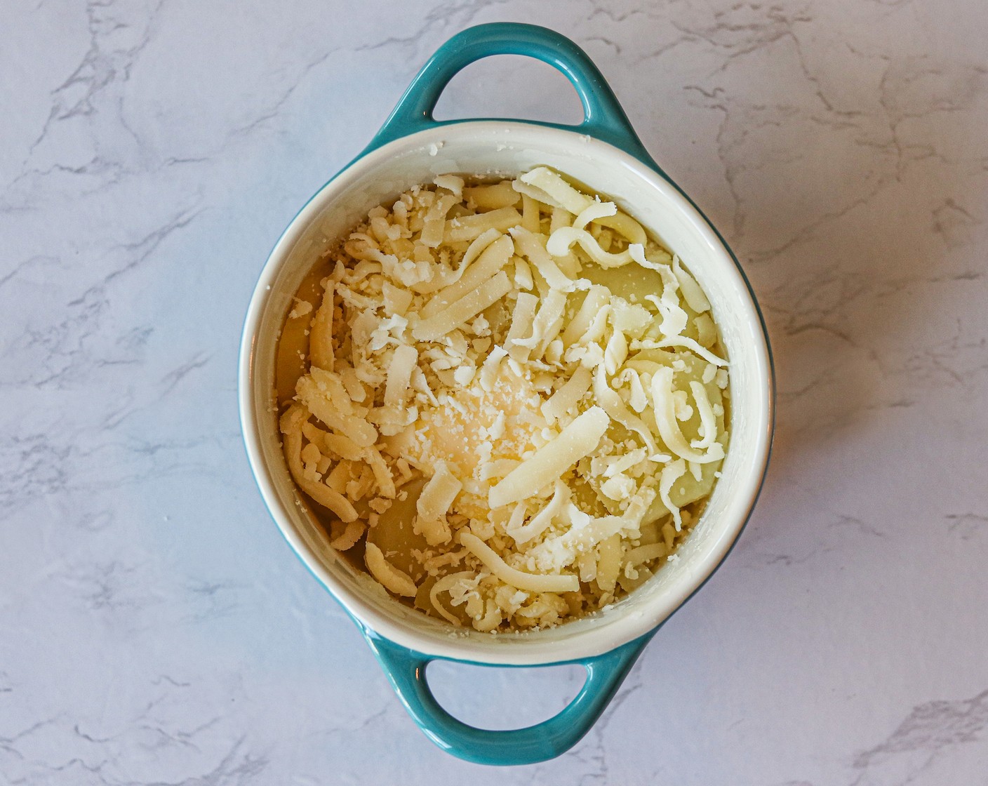 step 6 Top each casserole dish with 1 Tbsp of Butter (1/4 cup) and 2 Tbsp of Shredded Mozzarella Cheese (1/2 cup).