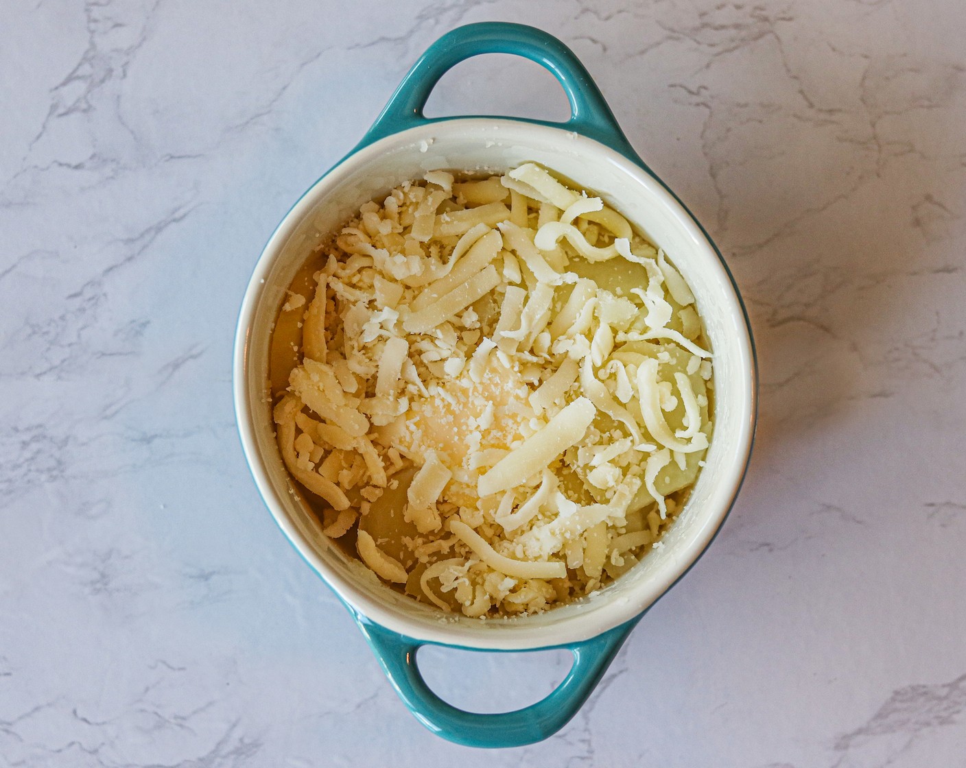 step 6 Top each casserole dish with 1 Tbsp of Butter (4 Tbsp) and 2 Tbsp of Shredded Mozzarella Cheese (1/2 cup).