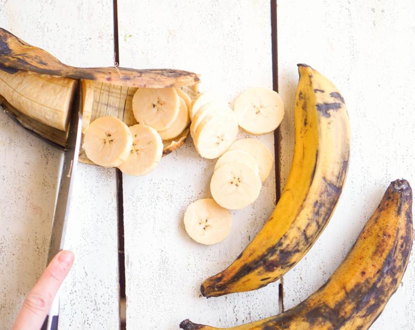 step 3 Peel and slice the Plantains (3) into rounds, add to the baking sheet and toss to coat in the oil.