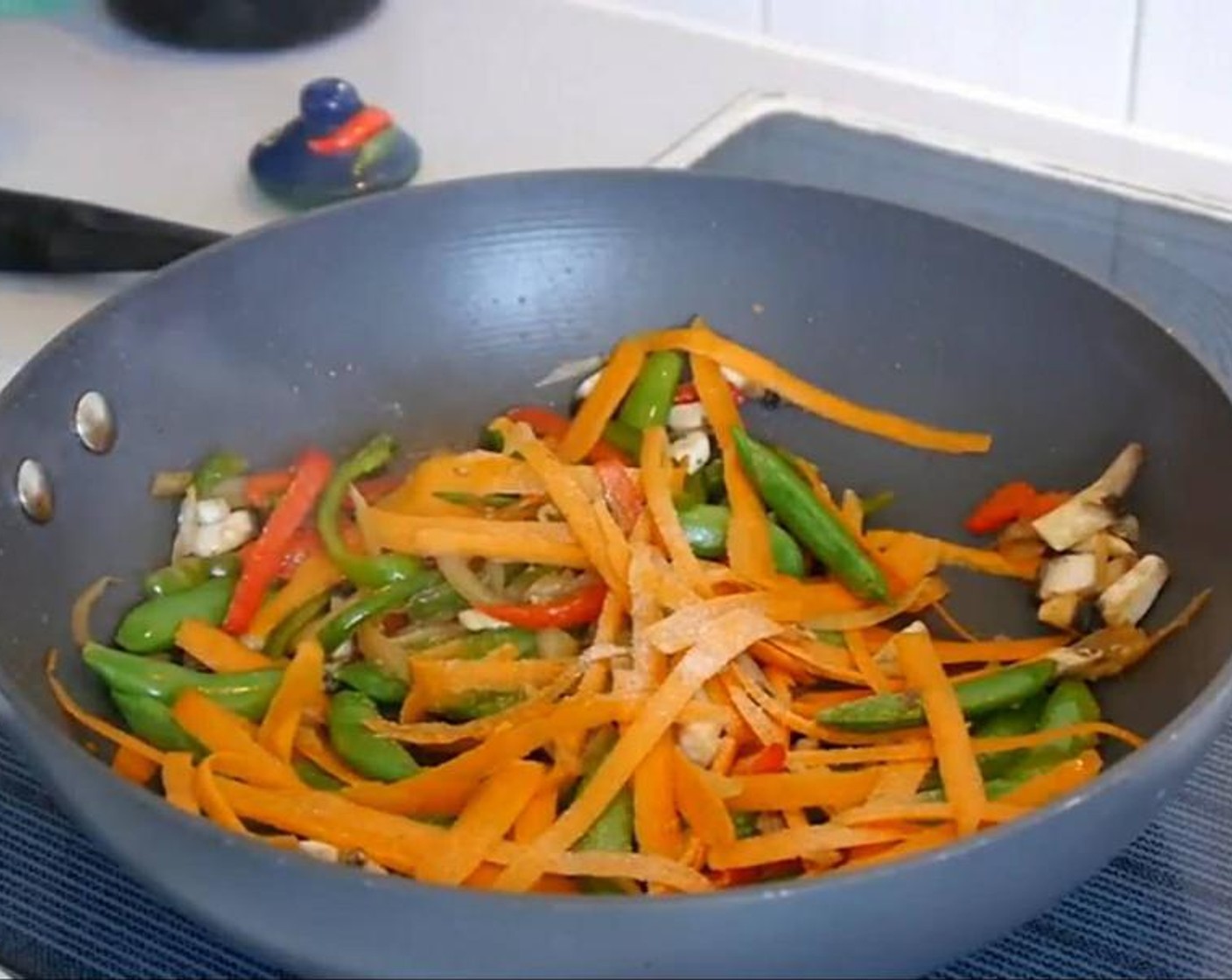 step 4 Add the Mushrooms (6) and stir again. Leave to cook for a couple of minutes. Then add the Carrot (1) which I previously made using a vegetable peeler to make very thin slices (see video), stir, and leave to cook. Season with Salt (to taste), Ground Black Pepper (to taste), and Crushed Red Pepper Flakes (1 pinch), stir, and leave to cook for a couple of minutes.