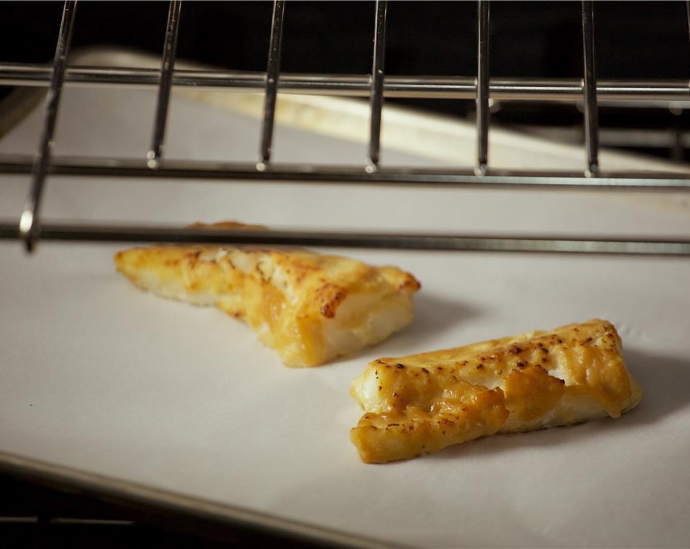 step 6 Place cod fillets on a sheet pan lined with parchment paper and roast for 8 minutes until fillets are fork tender and caramelized. Remove from oven and keep warm for plating.