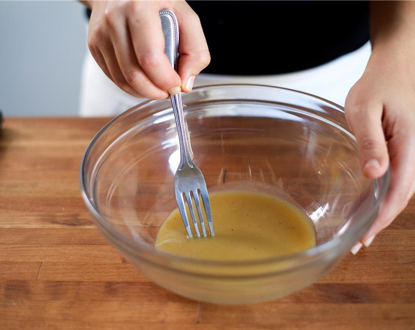 step 3 In a large bowl, add Dijon Mustard (2 Tbsp), Champagne Vinegar (2 fl oz), Honey (2 Tbsp), Salt (1/4 tsp), and Ground Black Pepper (1/4 tsp). Slowly drizzle Olive Oil (2 Tbsp) into the bowl. Using a fork, whisk until smooth and emulsified. Set aside.