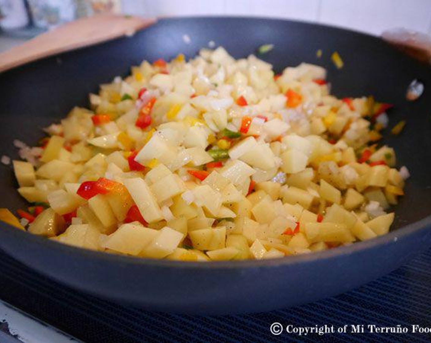 step 3 In a deep pan, place Olive Oil (1 cup). Once the oil is hot add the potatoes, peppers, and onion and toss everything together well. Cook for about 20 minutes until everything is soft.