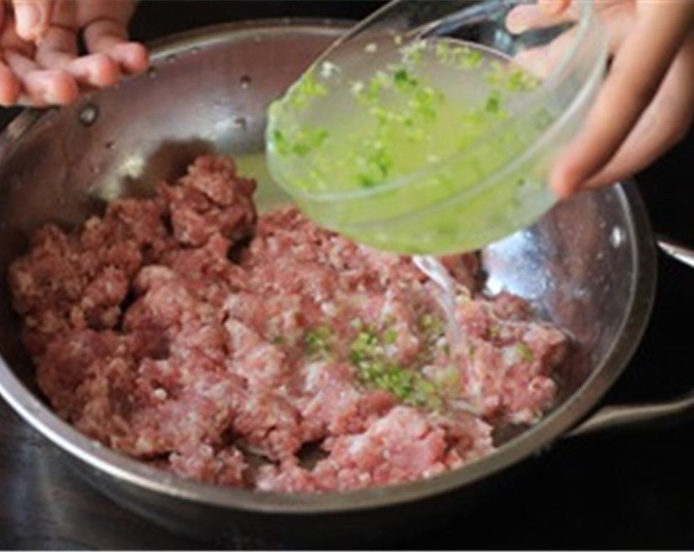 step 5 In a large mixing bowl, mix the ginger and green onion water with the Ground Pork (1 lb) by three batches. Use your hand to stir in one direction until the water is completely absorbed by the minced pork.