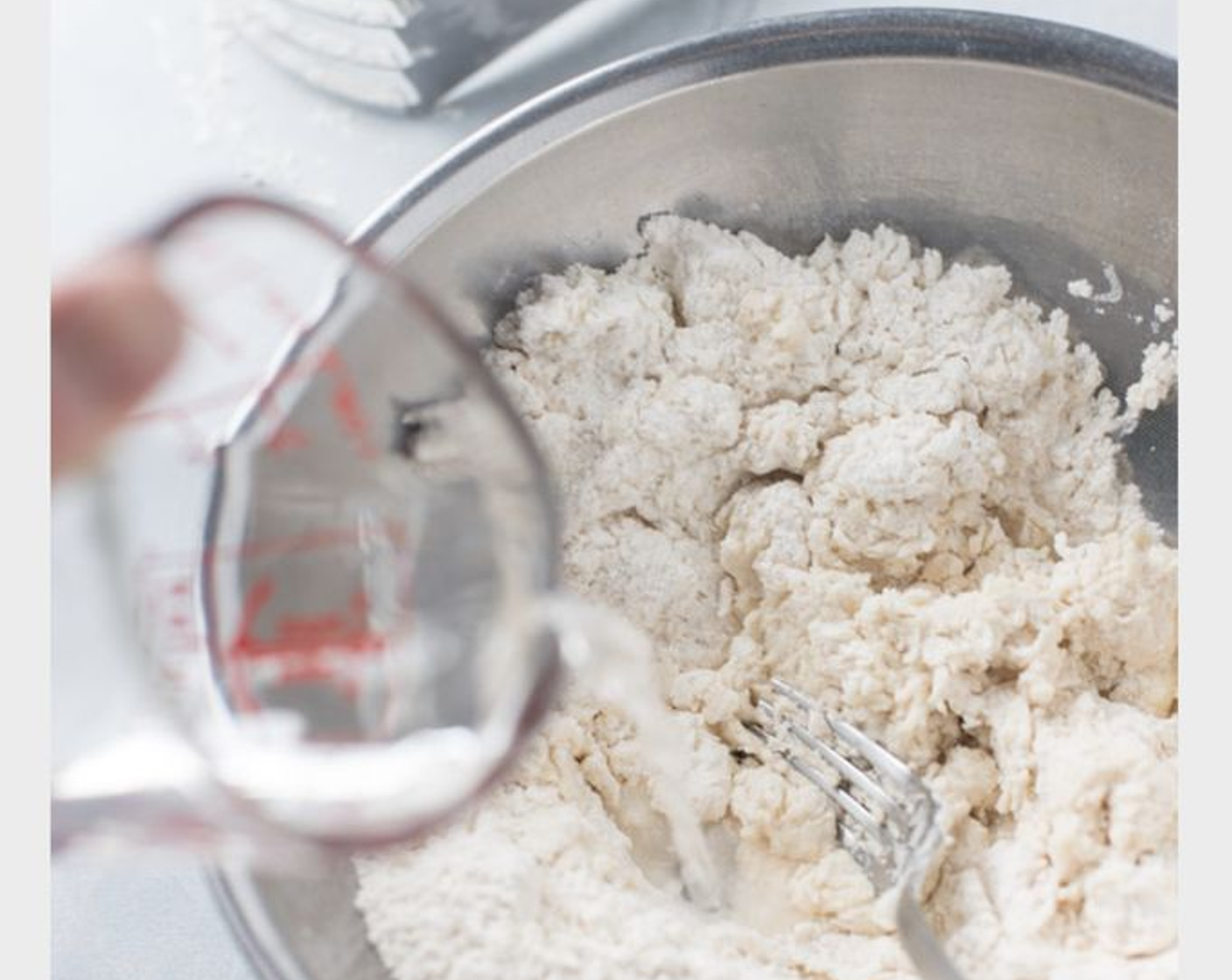 step 3 Slowly stir in Water (3/4 cup) forming into a dough. Pour contents onto work surface and knead for one to two minutes.