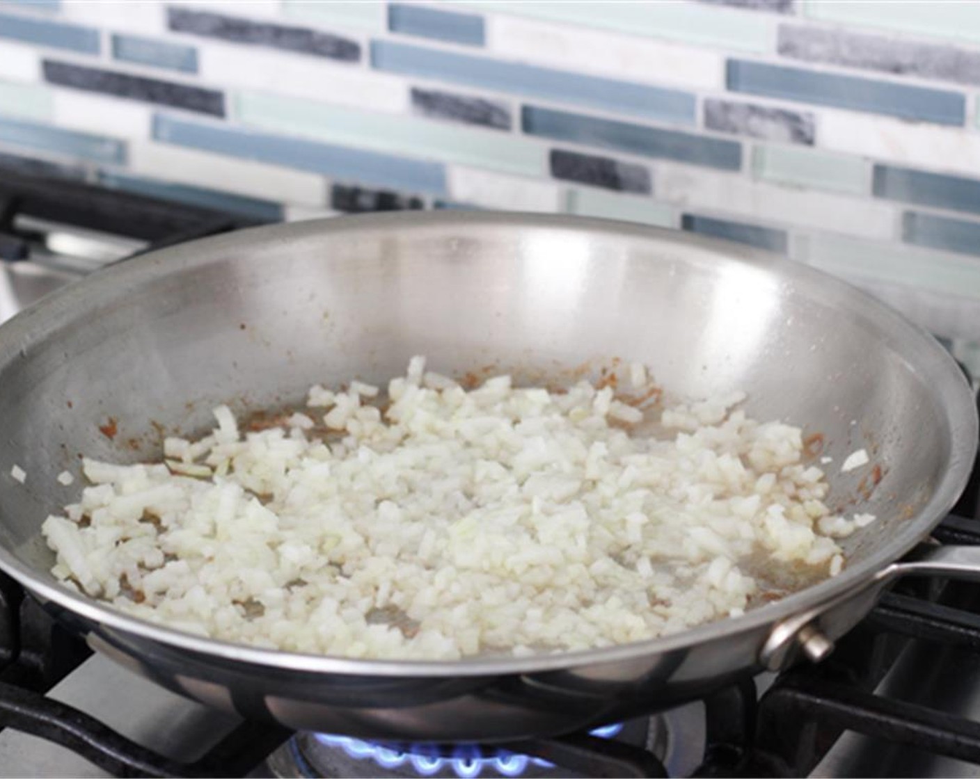 step 2 Reduce heat to medium low and add the chopped Onion (1) and minced Garlic (1 clove), seasoning with Salt (to taste)) and ground Ground Black Pepper (to taste).