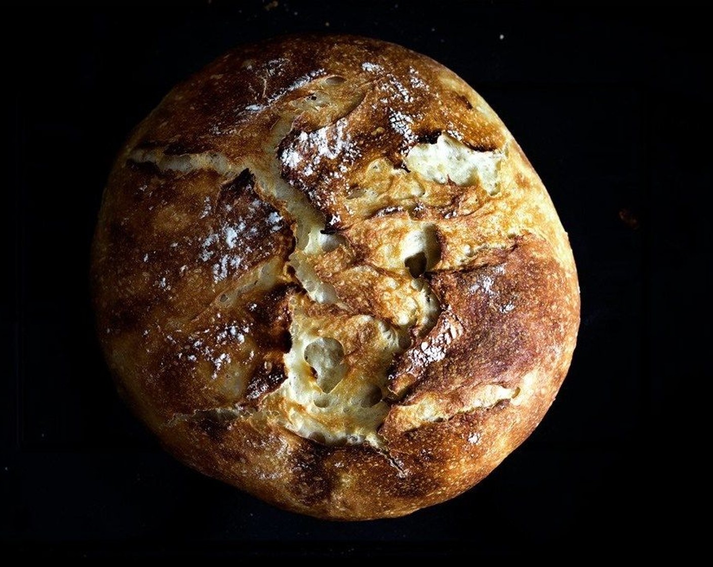 step 10 To bake the bread, lift the parchment paper to transfer the dough into the preheated pot, cover the lid and bake for 30 min. Then remove the lid, and bake until the crust is golden brown.