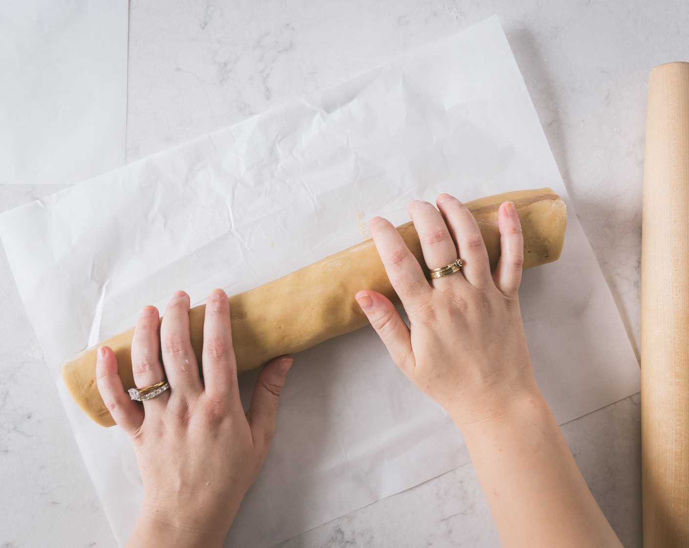 step 10 Roll the dough together from long end to short end. Roll the dough back and forth to adhere.