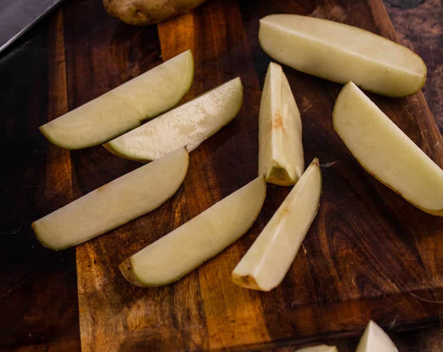 step 2 Wash and dry the Russet Potatoes (5) and cut them into similar-sized wedges. 4-6 wedges per potato work best.