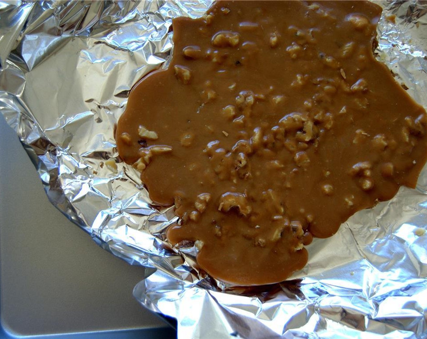 step 7 Sprinkle the Assorted Nuts (1/2 cup) on a large baking sheet lined with foil or parchment, pour the toffee liquid on top of it.