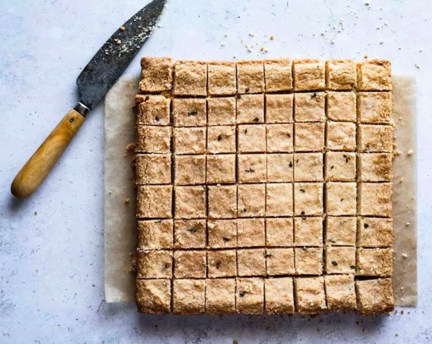 step 7 Remove from the oven and let the shortbread cool for 15 minutes in the pan before carefully transferring it out and onto a wire rack. Slice the shortbread into even squares while it is still warm.