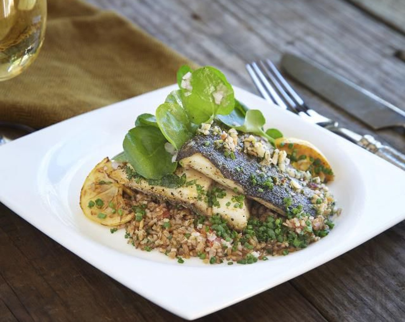 step 21 Drizzle the salsa verde on top and around the trout. Put the watercress salad on top. Garnish with a seared lemon slice. Serve and enjoy!