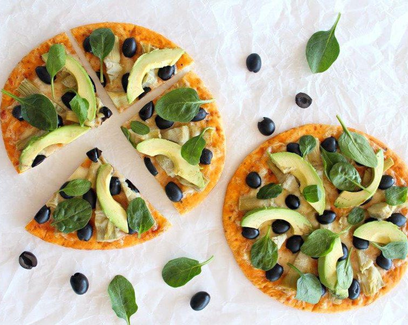 step 4 Place the Avocado (1) on the pizzas and scatter with the Fresh Baby Spinach (1/2 cup). Slice and serve. Enjoy!