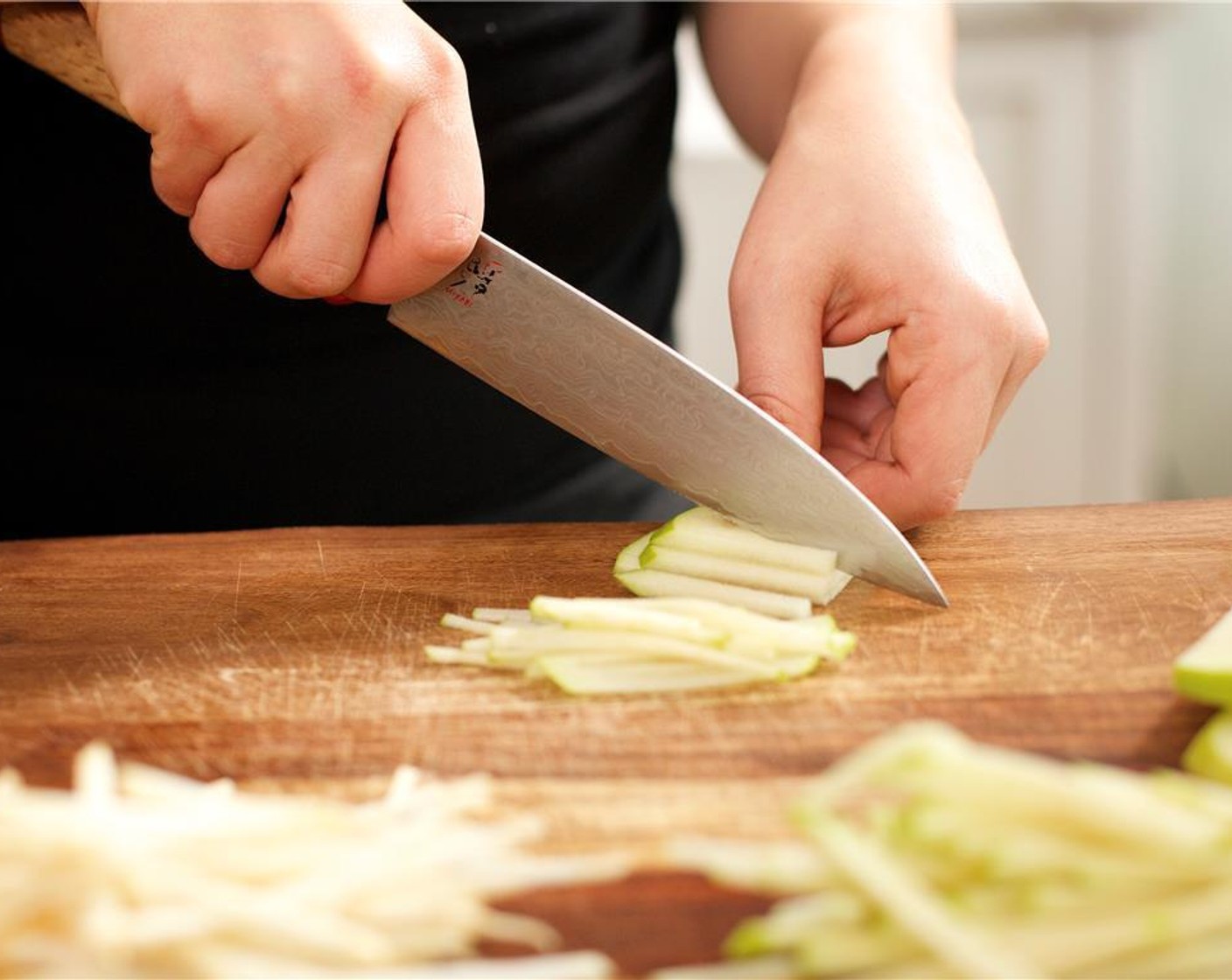 step 2 Cut Celery Root (4 oz) into eighth of an inch slices, and stack the slices. Continue to cut into matchstick sized slices and place into a medium bowl.