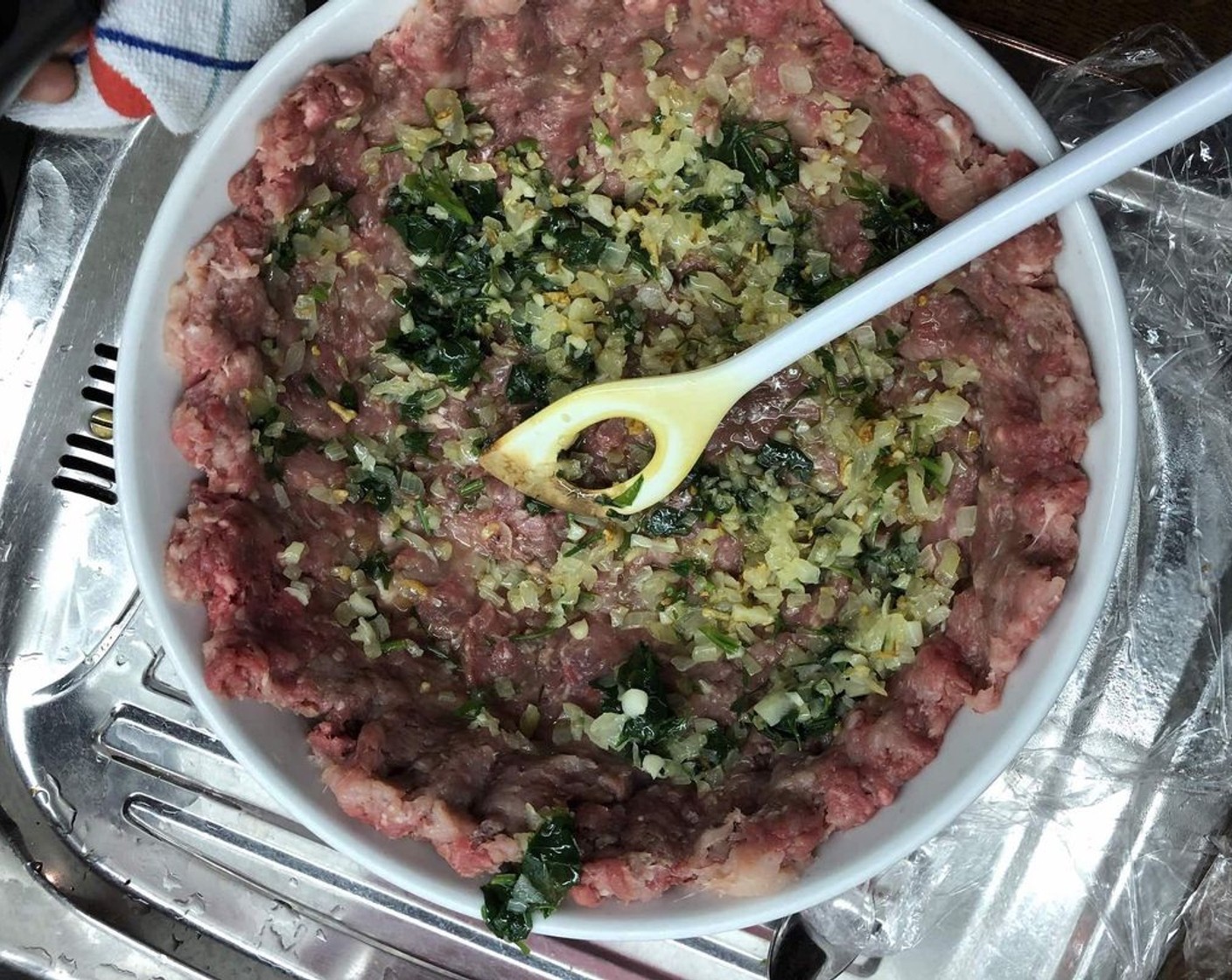 step 8 Spread cooked garlic-onion mixture to the flattened ground beef.