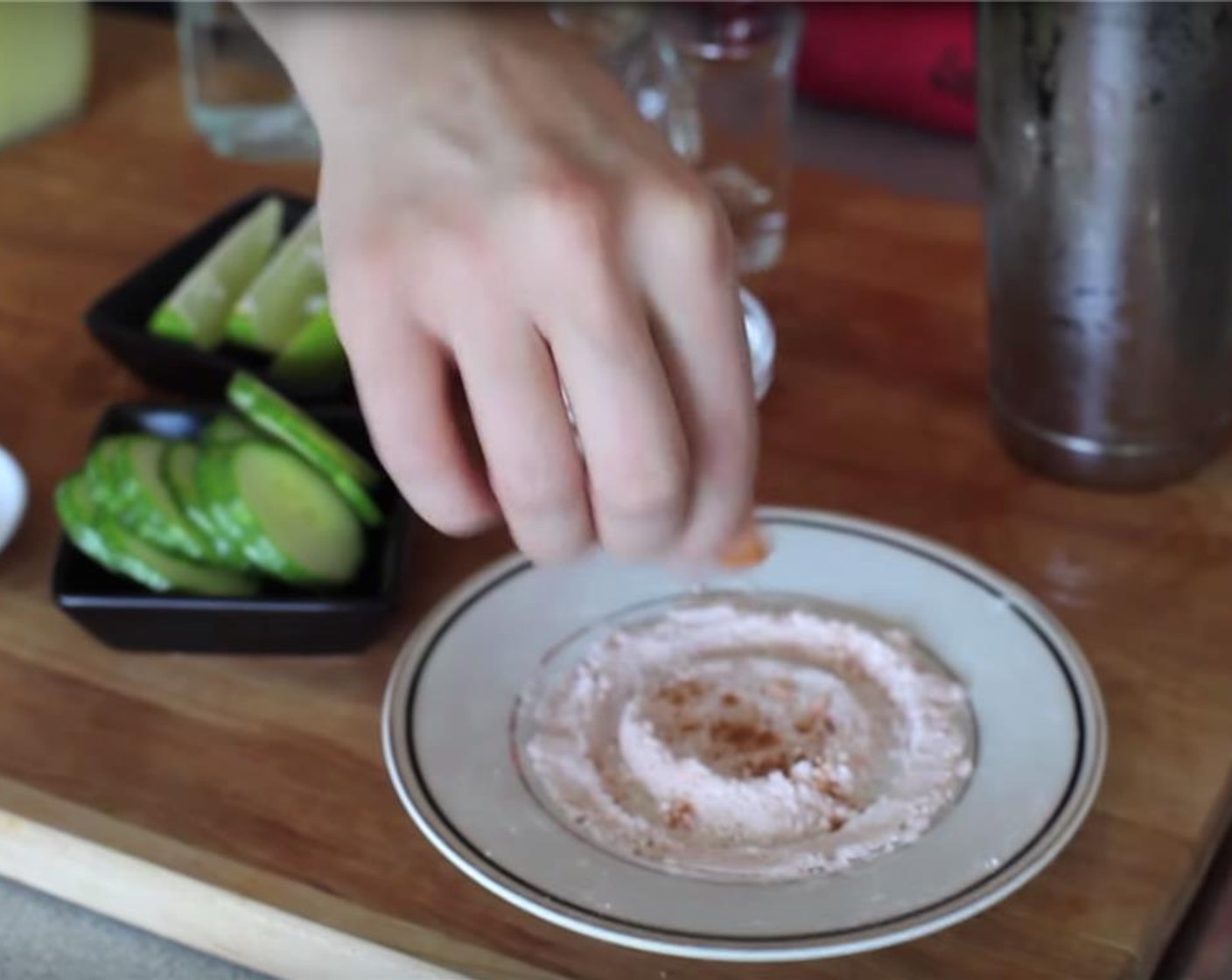 step 2 On a small plate, pour out some Salt (to taste). Then spin the glass around upside down on the salted plate to coat the rim.