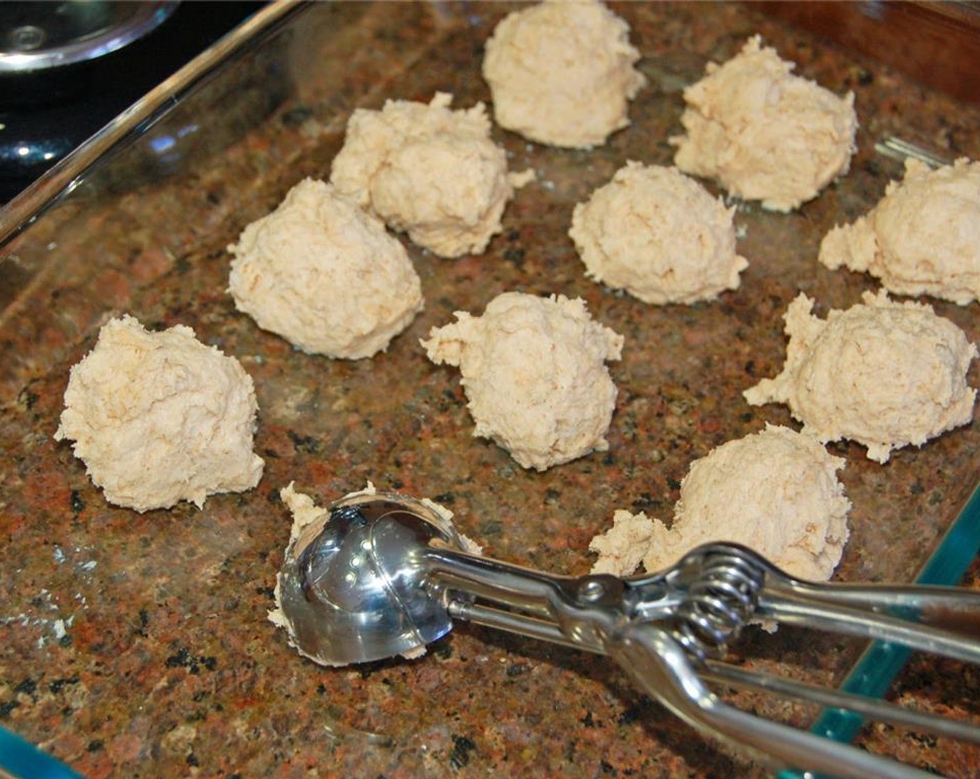 step 3 With a large scoop, scoop dough into even balls and place in a 9x13-inch glass dish.