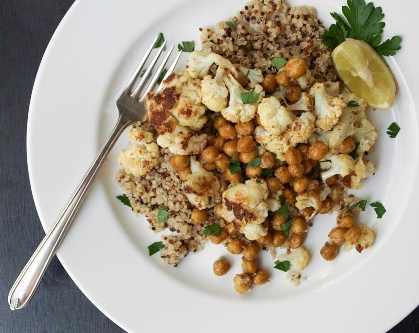 step 7 Serve cauliflower and chickpea mix over a nice bowl of quinoa, and garnish with a sprinkle of Italian Flat-Leaf Parsley (1/4 cup). Tastes great warm or at room temperature.