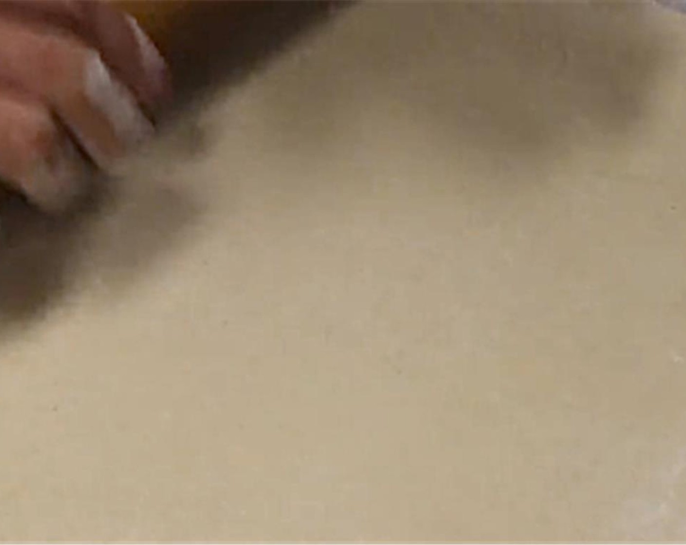 step 8 Sprinkle your work surface, rolling pin, and dough with flour. Take one of the four portions of dough and lightly flatten. Begin to roll the dough out to a square shape, roughly the width of 3 hands side by side.