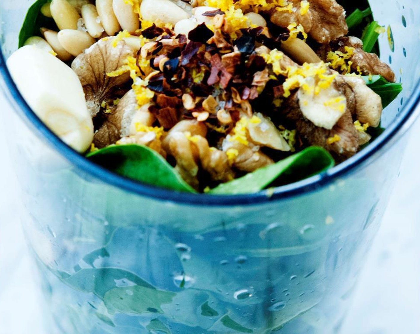 step 1 Wash the Fresh Baby Spinach (2 cups) then place the Walnut (1/2 cup), Extra-Virgin Olive Oil (4 Tbsp), Garlic (1 clove), Coarse Salt (1 tsp), zest from Lemon (1/8), Fresh Basil (4 Tbsp) and Freshly Ground Black Pepper (to taste) into a deep glass, then blend until creamy.