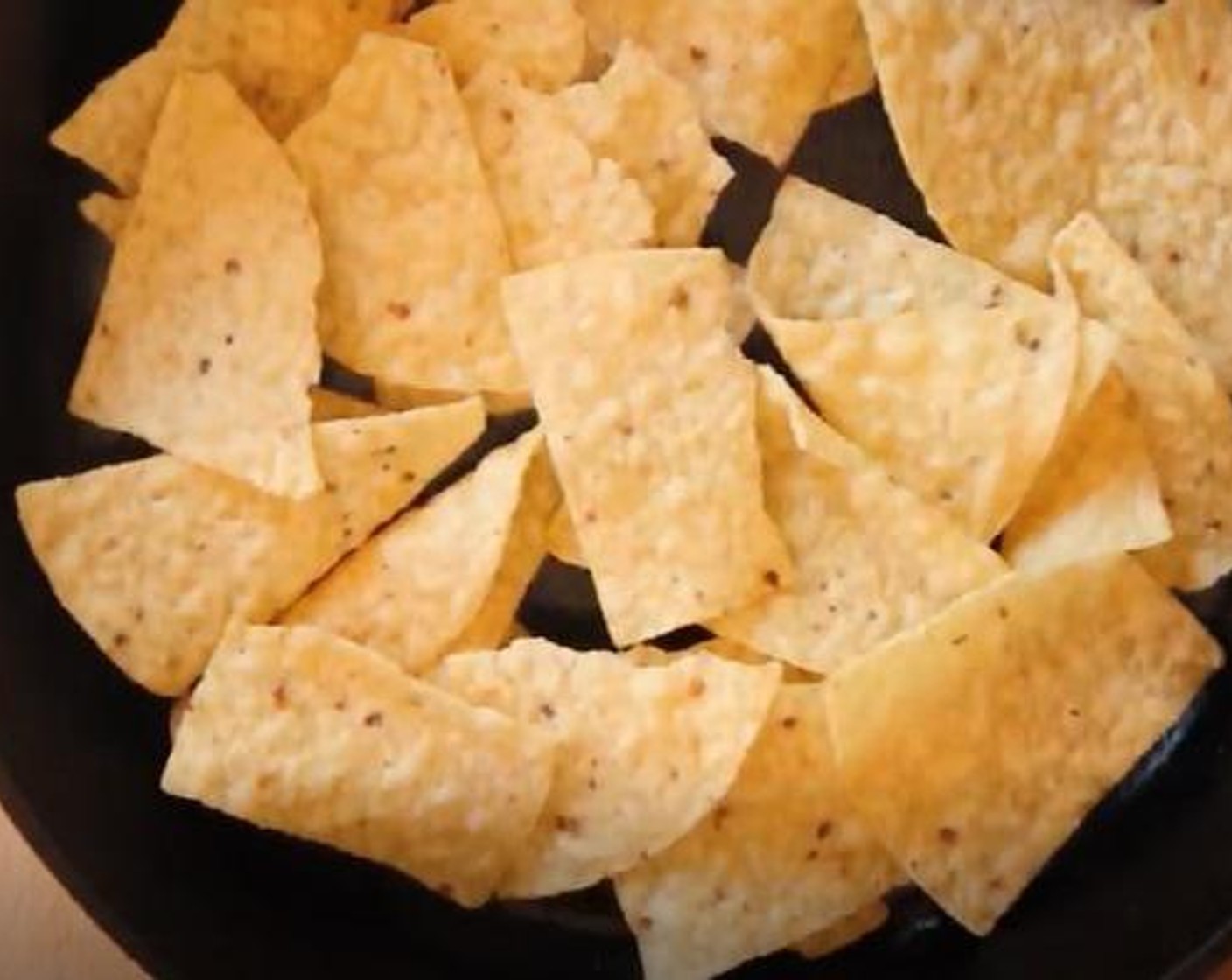 step 4 Take out your cast iron skillet. Put one layer of Restaurant Style Tortilla Chips (1 pckg) at the bottom.