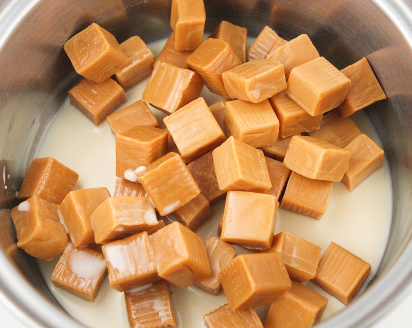 step 9 Add the Caramel Candies (1 3/4 cups) and Evaporated Milk (1/4 cup) to a small saucepan. Cook over medium-low heat, stirring constantly, until caramel is melted and smooth.