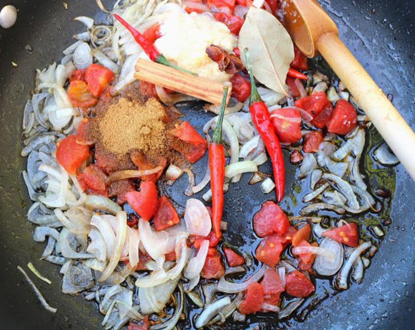 step 5 Add Canned Diced Tomatoes (1 cup), Cinnamon Stick (1/2), Chili Peppers (3), Bay Leaf (1), Ground Cumin (1 Tbsp), Ground Coriander (1 Tbsp), saute until fragrant.