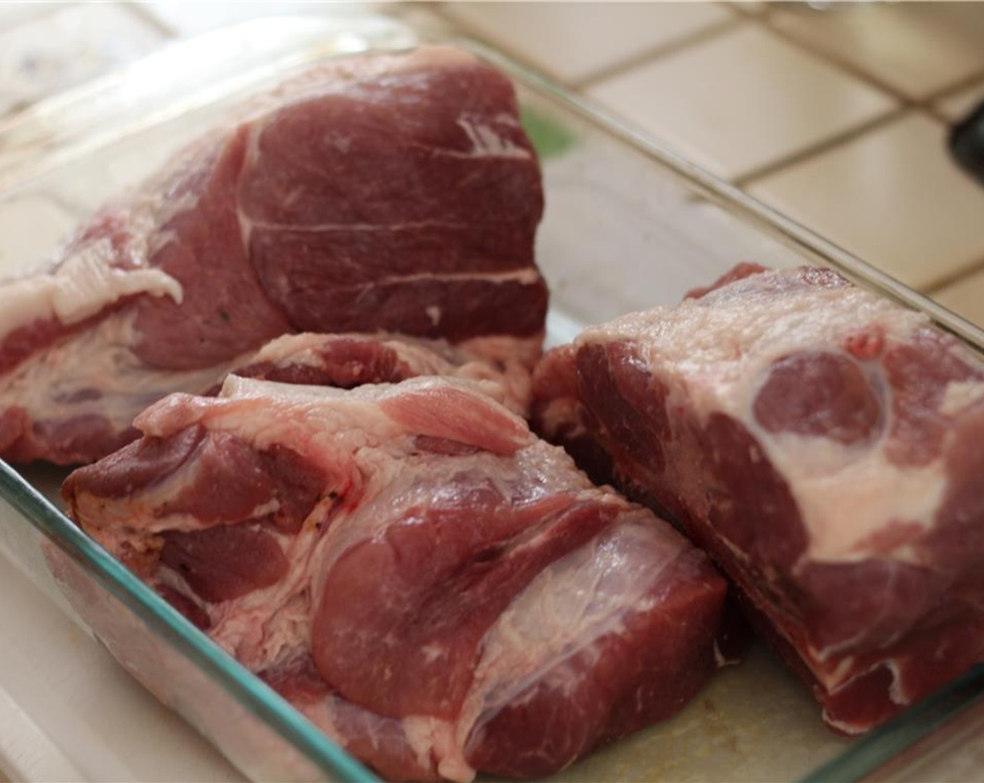 step 6 Season the pork shoulder liberally with Kosher Salt (to taste) and freshly ground Ground Black Pepper (to taste) on every side.