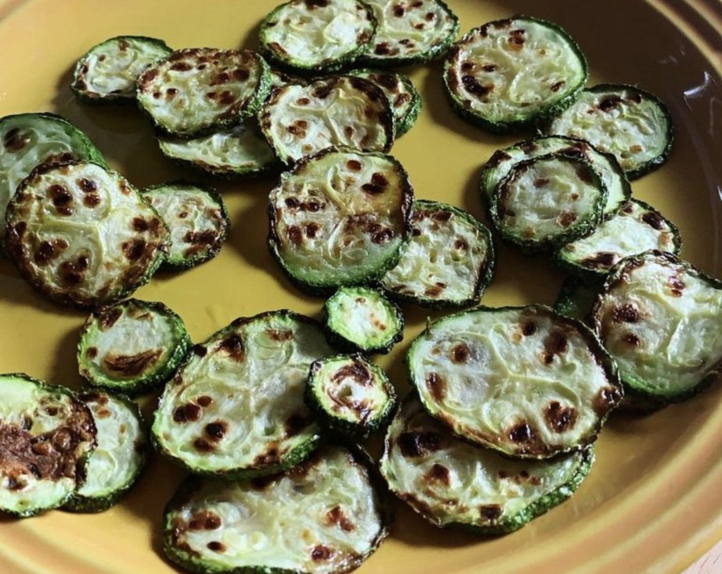 step 1 In a skillet, heat up Olive Oil (1/2 Tbsp). Slice up the Zucchini (2), season with Salt (to taste) and Ground Black Pepper (to taste), and cook them on both sides until crispy.