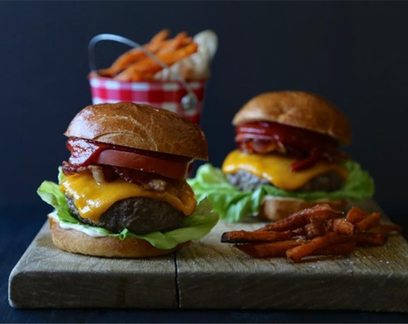 step 7 Place patties on top of Brioche Hamburger Buns (4) and garnish with Bacon (4 slices), Butter Lettuce (4 pieces), Tomatoes (4 slices), Red Onions (as needed), and Mayonnaise (to taste). Enjoy!