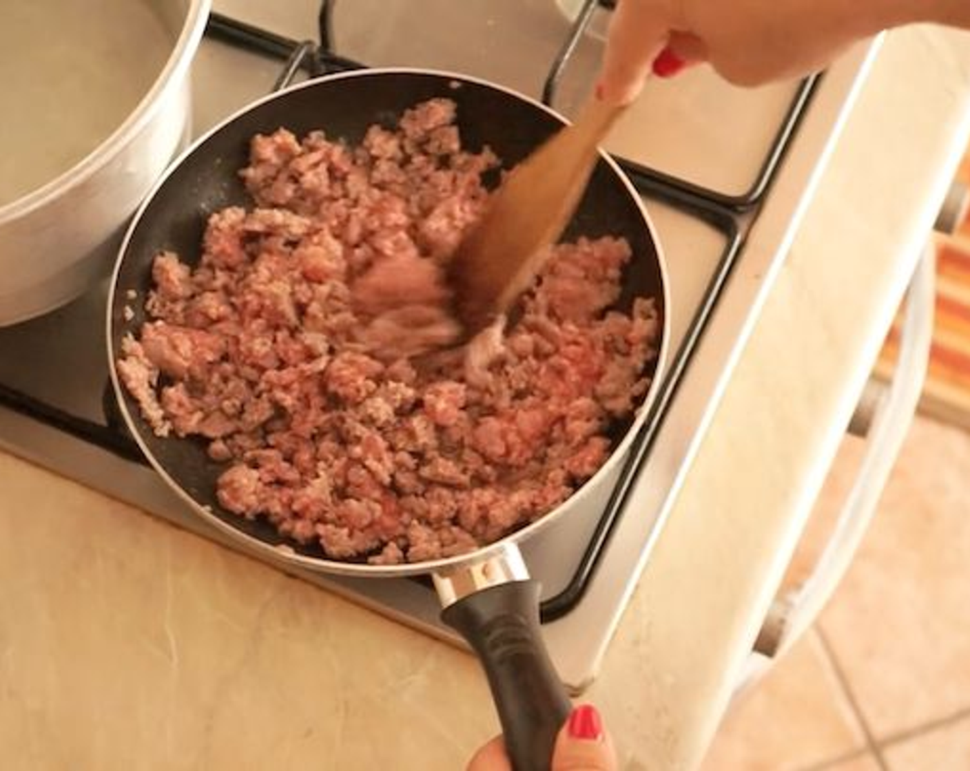 step 6 Cook this on a low-medium heat until well browned, adding Veal (3.5 oz) and a pinch of Fine Salt (to taste). Mix this through and ensure it is well browned by moving the meat around with a wooden spoon.