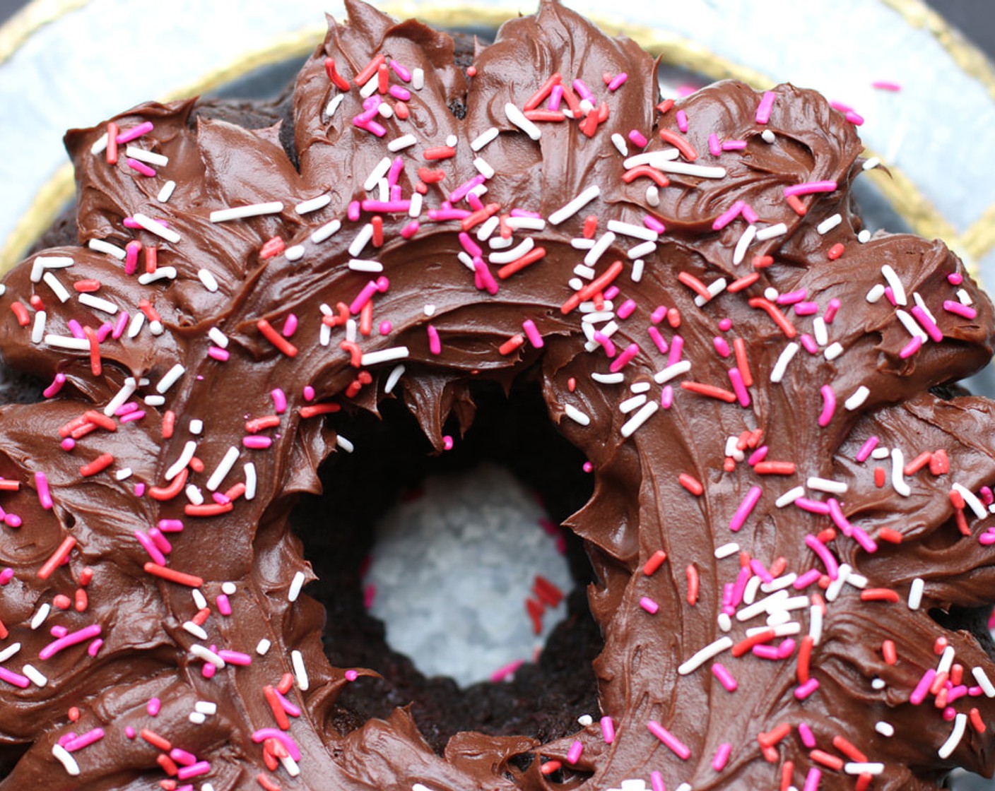 step 12 Place the cake on a serving platter and pour the ganache evenly over the top of the cake. Add mini chocolate chips or sprinkles if you would like! The cake can be kept, covered, at room temperature for up to 5 days.