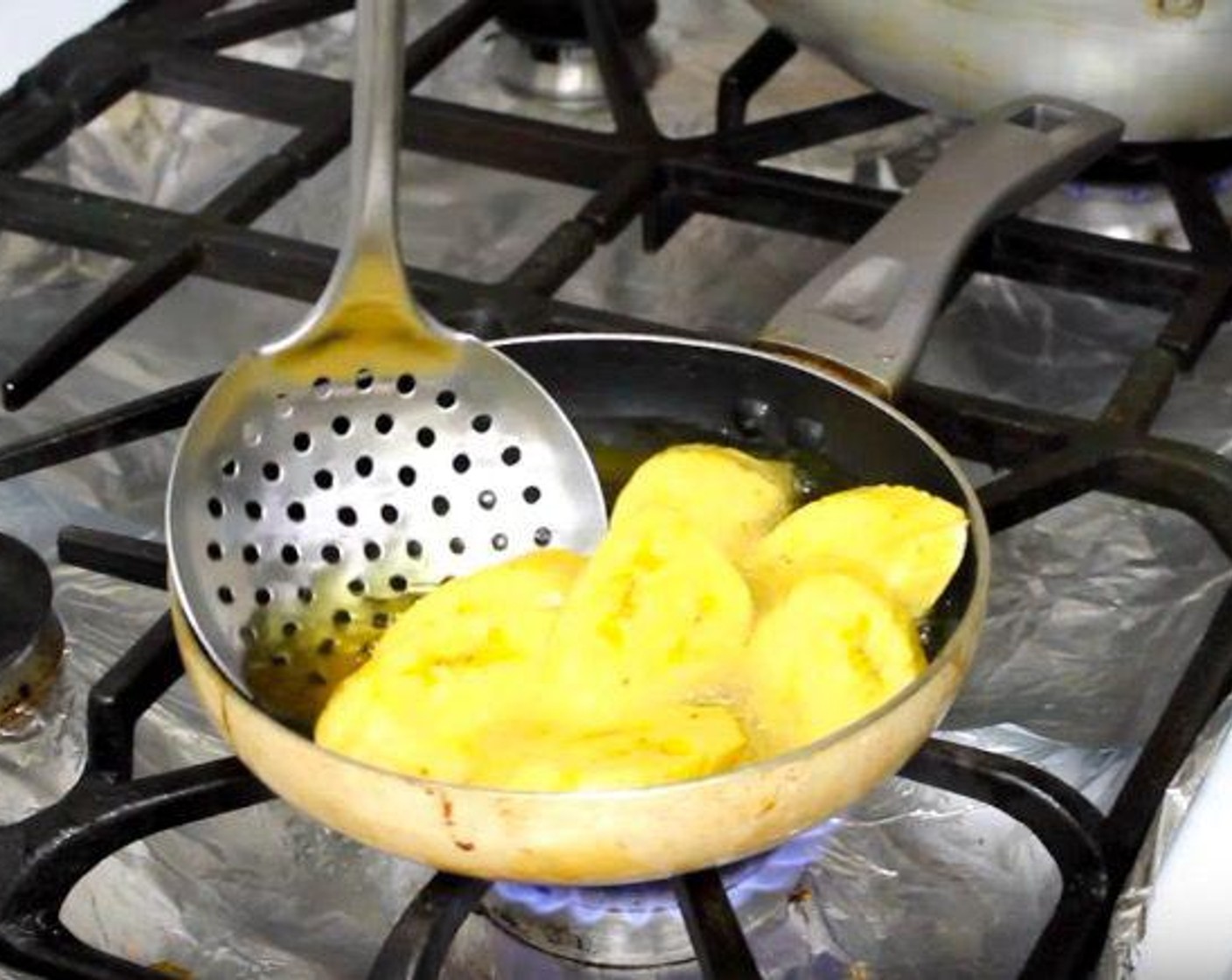 step 3 Remove with slotted spoon and transfer to a plate lined with paper towels to drain the oil.