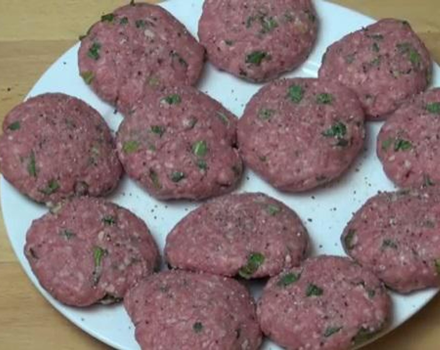 step 2 Divide the mixture into four even portions. Make 3 patties from each portion, and place them on a separate dish. Season with Salt (to taste) and Ground Black Pepper (to taste).