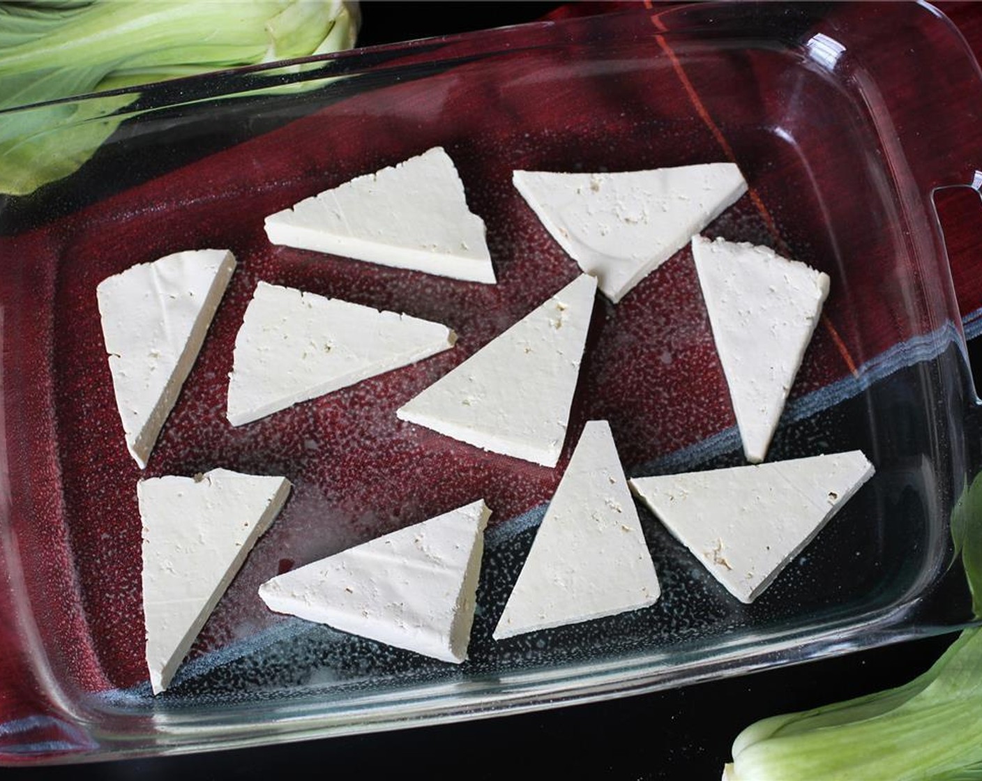step 5 Preheat the oven to broil. Cut the tofu into squares or triangles and place on a greased baking dish.