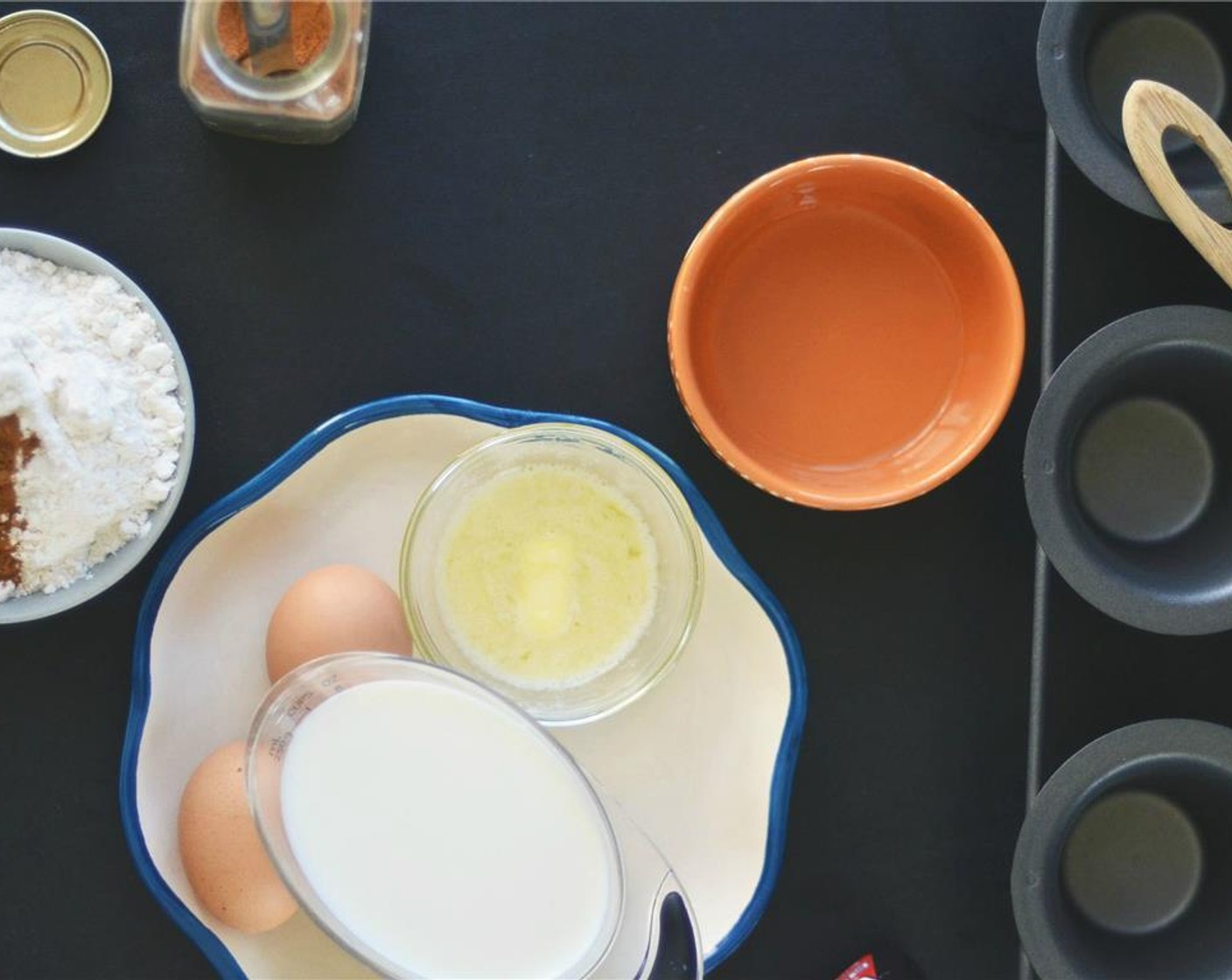 step 5 Once the oven is preheated, place muffin or popover tin in the oven for 2 minutes to heat up. Remove tin from oven and brush each cup with the Vegetable Oil (2 Tbsp).