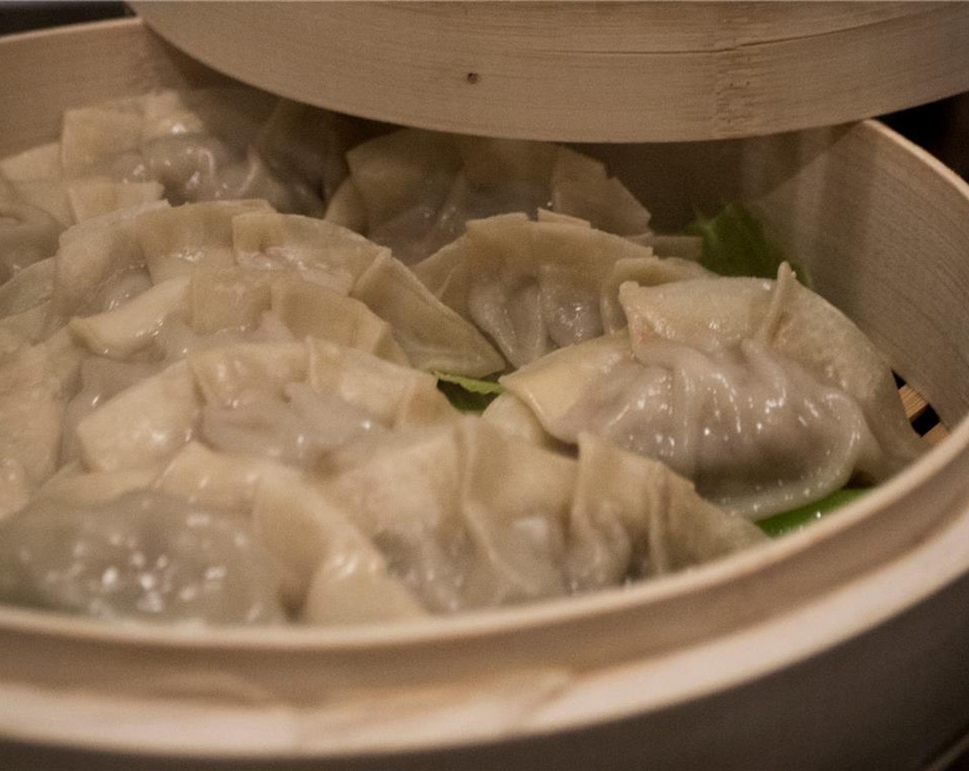 step 8 Line a bamboo steamer or vegetable steamer with any remaining cabbage leaves. Alternatively, you can cut out a round of parchment paper to line. Place each dumpling in the steamer, being careful to not let them touch each other or the bamboo sides, otherwise, they will stick.